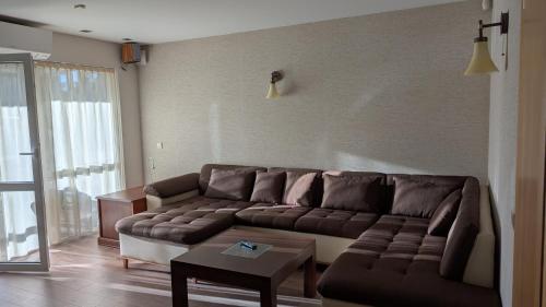 a living room with a couch and a table at Taikos 7 in Nida