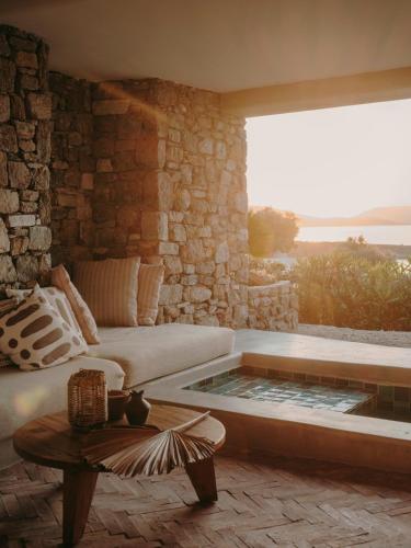 a living room with a couch and a coffee table at The Wild by Interni in Kalafatis