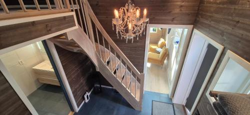 an overhead view of a staircase with a chandelier at Andøy Vest Rorbuer Reine in Reine