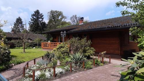 a log cabin with a garden in front of it at Blockhaus Ville in Thören