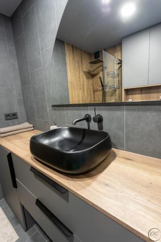 a bathroom with a black sink on a counter at Palanga studio in Palanga