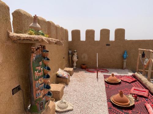 a room with a wall with a bunch of hats at Château Berbère Madame DELLAL in Taroudant