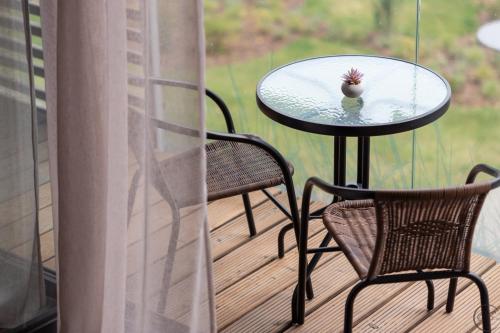 a bird sitting on a table on a porch at Palanga studio in Palanga