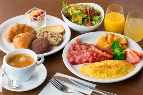 a table topped with plates of breakfast foods and drinks at Ki Niseko in Kutchan
