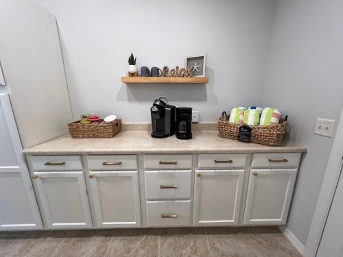 a kitchen counter with baskets on top of it at Delia Place Florida Oasis With Private Lanai in The Villages