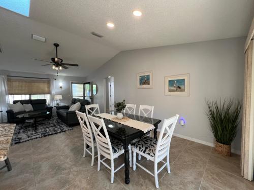 a dining room and living room with a table and chairs at Delia Place Florida Oasis With Private Lanai in The Villages