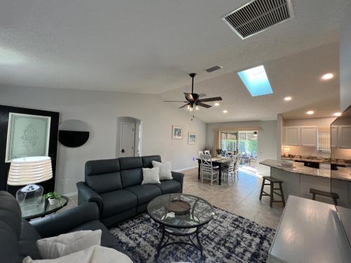 a living room with a couch and a table at Delia Place Florida Oasis With Private Lanai in The Villages