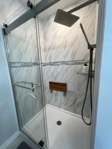 a shower with a glass door in a bathroom at Delia Place Florida Oasis With Private Lanai in The Villages