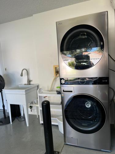 a washing machine in a kitchen next to a sink at Delia Place Florida Oasis With Private Lanai in The Villages
