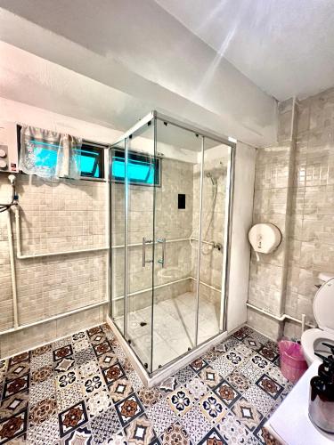 a glass shower in a bathroom with a toilet at 77 Old Town in Bangkok
