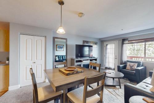 a living room with a table and a couch at First Tracks 4202 in Steamboat Springs