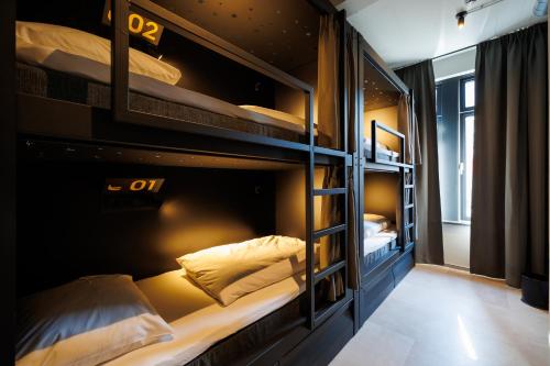 a room with two bunk beds in a hostel at Little Monkey Hostel in Enschede