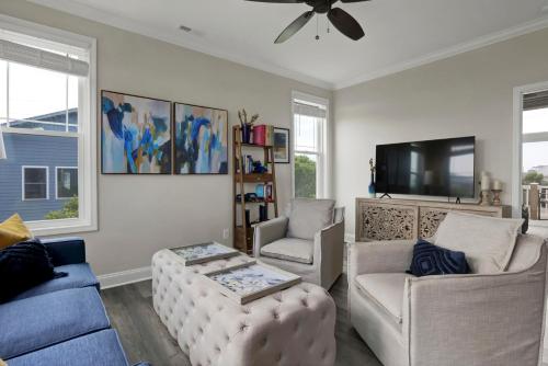 a living room with a couch and a tv at Oshun by Sea Scape Properties in Surf City