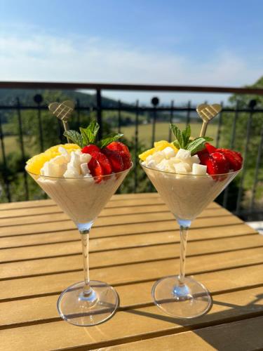 two martini glasses filled with fruit on a table at Wellness apartmány Český ráj & Biokolna in Lomnice nad Popelkou