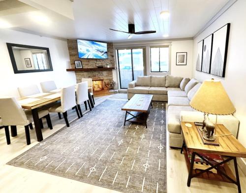a living room with a couch and a table at Remodeled Ski in and ski out Condo! in Breckenridge
