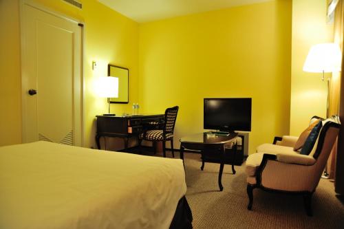 a hotel room with a bed and a desk and a television at Hotel New Otani Nagaoka in Nagaoka