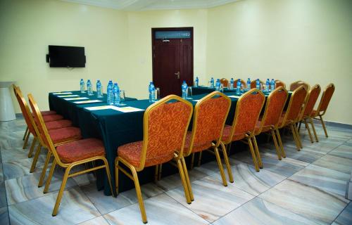 a conference room with a long table and chairs at Golden Tulip Hotel -GT31 Stadium Road in Port Harcourt