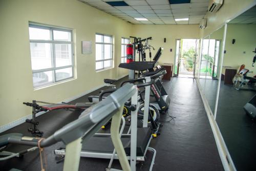 a gym with several tread machines in a room at Golden Tulip Hotel -GT31 Stadium Road in Port Harcourt