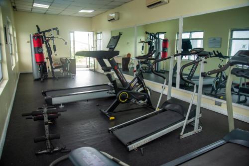 a gym with several treadmills and machines in it at Golden Tulip Hotel -GT31 Stadium Road in Port Harcourt