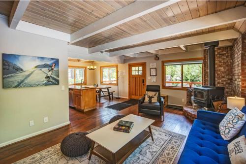 a living room with a blue couch and a table at Hot tub - Play structure - Mini pool table game in South Lake Tahoe