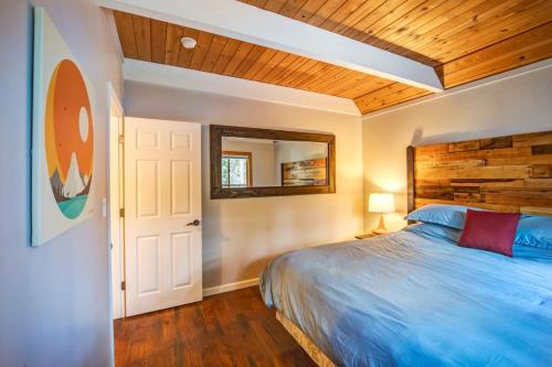 a bedroom with a blue bed and a wooden ceiling at Hot tub - Play structure - Mini pool table game in South Lake Tahoe