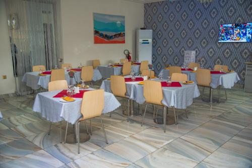 a conference room with tables and chairs at Golden Tulip Hotel -GT31 Stadium Road in Port Harcourt