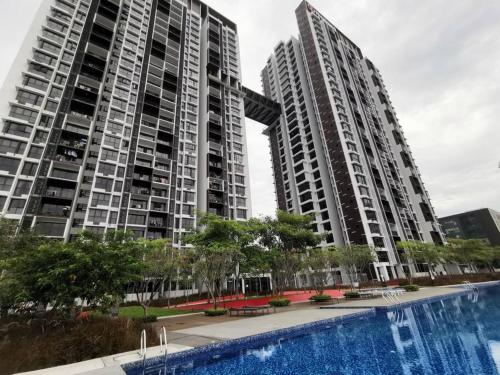 two tall buildings with a pool in front of them at Minimalist Retreat at The Mines-A19 in Serdang Lama