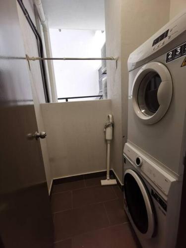 a washing machine in a bathroom with a window at Minimalist Retreat at The Mines-A19 in Serdang Lama