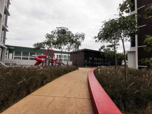 a sidewalk with a playground in front of a building at Minimalist Retreat at The Mines-A19 in Serdang Lama