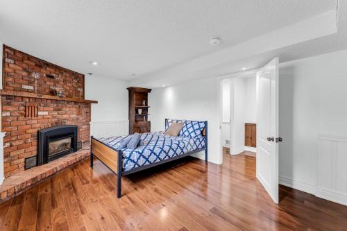 a living room with a couch and a fireplace at Cozy Home by Niagara Falls in Thorold