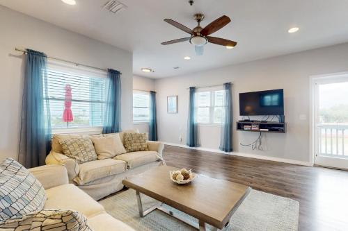 a living room with a couch and a table at Sharp Reef on the Gulf #5 in Pensacola
