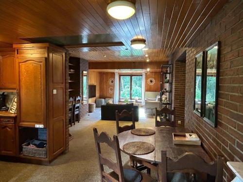 a living room with a table and chairs and a couch at Vakantiewoning Hoogveld in Kortessem