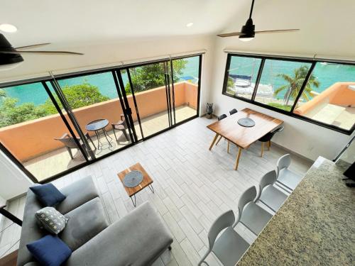 a living room with a couch and a table and chairs at Ocean & Marina views,Affordable,Spoil yourself! in Puerto Aventuras