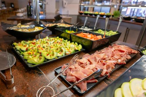 a buffet line with many different types of food at GF Fañabe in Adeje