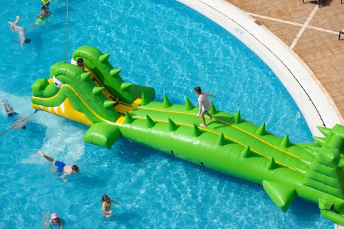 a water slide in a pool with people in it at GF Fañabe in Adeje