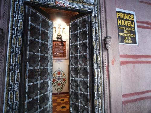 a door to a temple with a sign on it at The Prince Haveli in Bikaner