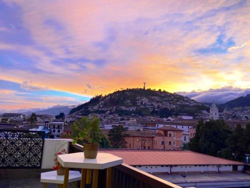 a view of a city from a balcony at sunset at Illa Experience Hotel in Quito