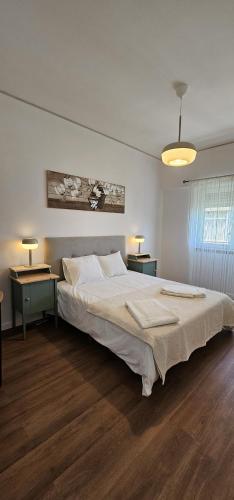 a bedroom with a large bed and two night tables at Benfica Flat in Lisbon