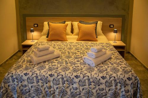 a bedroom with a bed with towels on it at Agriturismo Corte Casa Erminia in Colà di Lazise