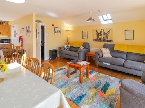 a living room with a couch and a table at Colliers Barn in Ballycastle