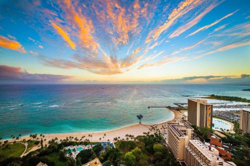 an aerial view of a beach at sunset at Honu Hale Penthouse 2 BDR Ocean View Waikiki in Honolulu