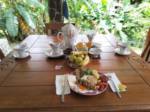a wooden table with a plate of food on it at Luxury apartmеnt with private terrace in Altos del Maria in Sorá