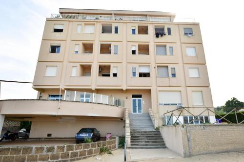 a building with a staircase in front of it at NON DISTA APARTMENT Appartamentino sul mare in Ortona