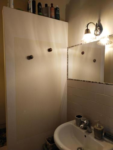 a bathroom with a sink and a mirror at L'angolo in Turin