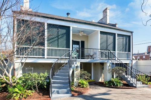 a white house with a balcony and stairs at Wilkins Townhouse - 3 Bed, 3 Bath, Walk to Downtown in Natchez