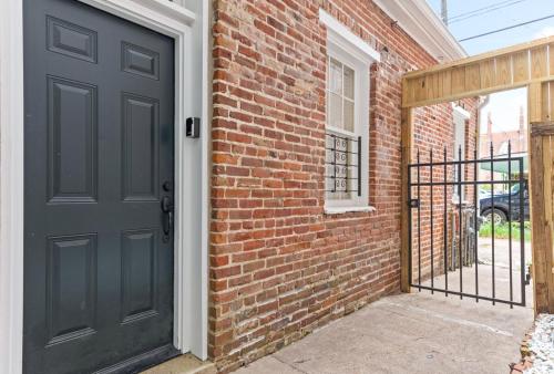 a brick building with a black door and a gate at 610 Franklin - 5B - 1 Bed, 1 Bath, Heart of Downtown, Washer & Dryer in Natchez