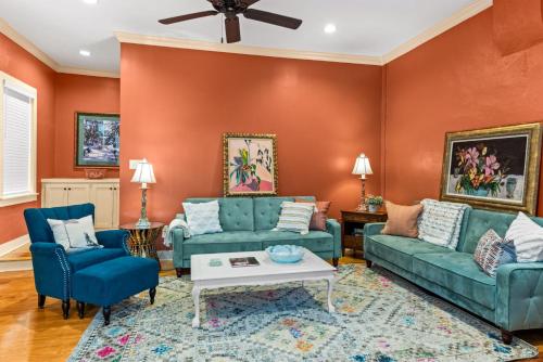 a living room with orange walls and blue couches at 610 Franklin - 5B - 1 Bed, 1 Bath, Heart of Downtown, Washer & Dryer in Natchez