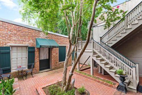 a brick building with a staircase next to a house at 610 Franklin - 5B - 1 Bed, 1 Bath, Heart of Downtown, Washer & Dryer in Natchez