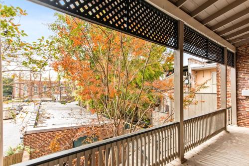 a balcony with a view of a tree at 610 Franklin - Upstairs - 1 Bed, 1 Bath, Sleeps 4, Walk to Downtown in Natchez
