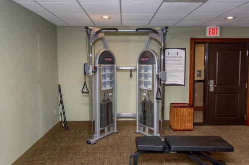 a gym with three exercise machines in a room at Staybridge Suites Bowling Green by IHG in Bowling Green